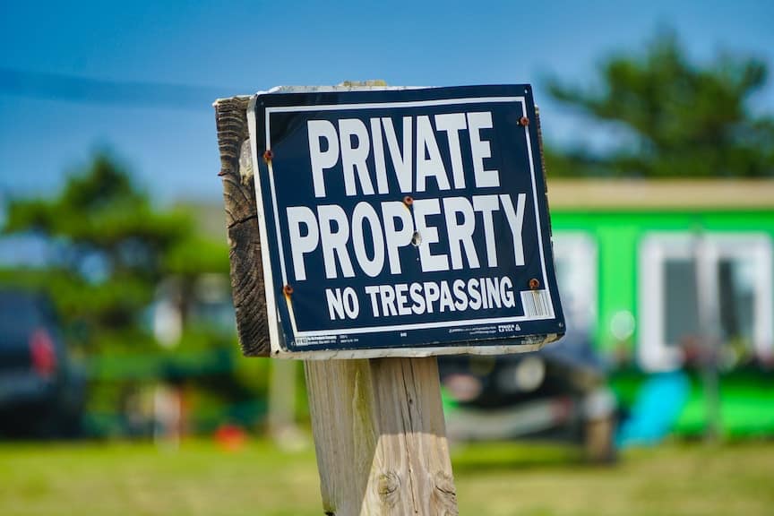 A black and white private property sign in front of a house The right of private property is a major theme in Catholic social teaching.